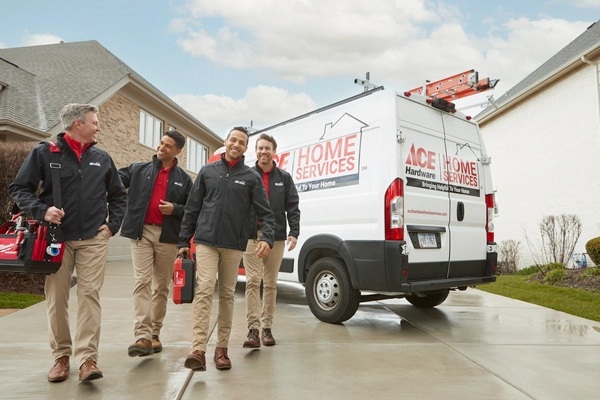 Ace Hardware Home Services plumbers next to a service van Ace Hardware Home Services plumbers next to a service van