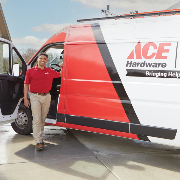 Ace Hardware Home Services electrician standing next to a service van Ace Hardware Home Services electrician standing next to a service van