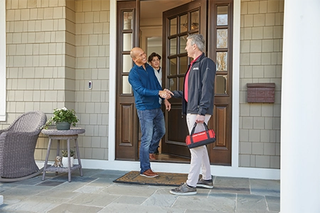 Ace Hardware Home Services technician greeting homeowners