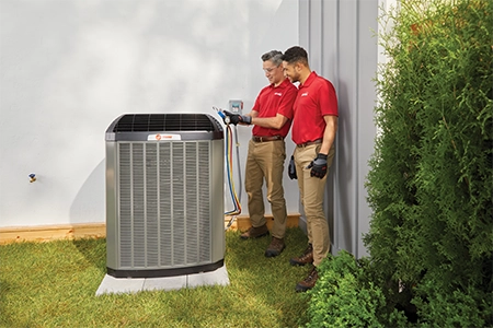 Ace Hardware Home Services technicians working on an air conditioner Ace Hardware Home Services technicians working on an air conditioner