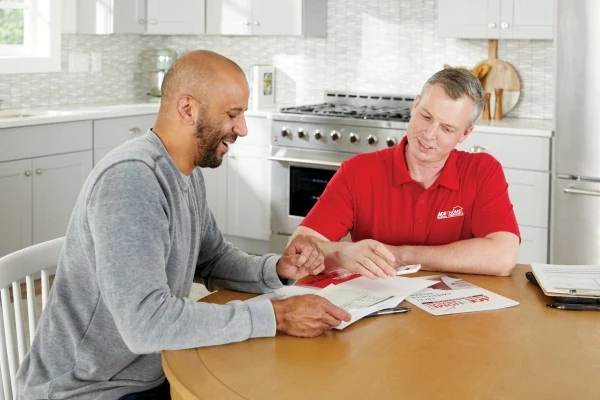 Ace Hardware Home Services technicians meeting with a homeowner