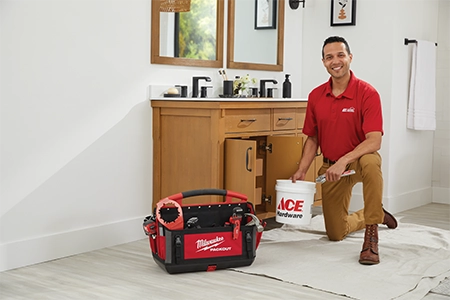 Plumber diagnosing bathroom sink drain clogs Plumber diagnosing bathroom sink drain clogs