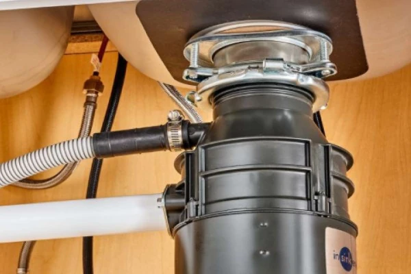 Garbage disposal underneath a kitchen sink Garbage disposal underneath a kitchen sink