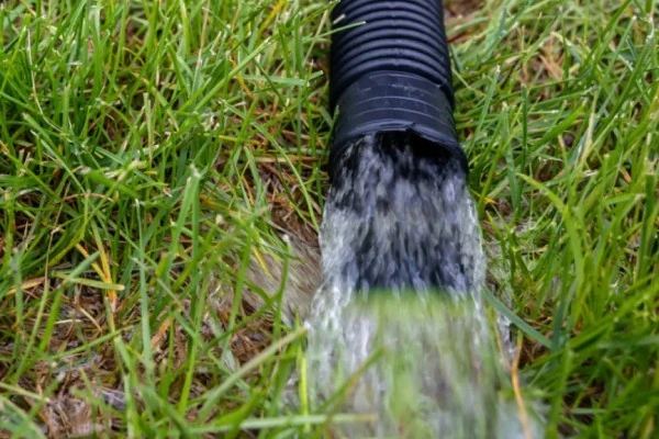 Sump pump draining water into yard Sump pump draining water into yard