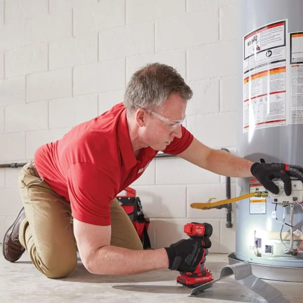 Ace Home Services technician repairing a water heater Ace Home Services technician repairing a water heater