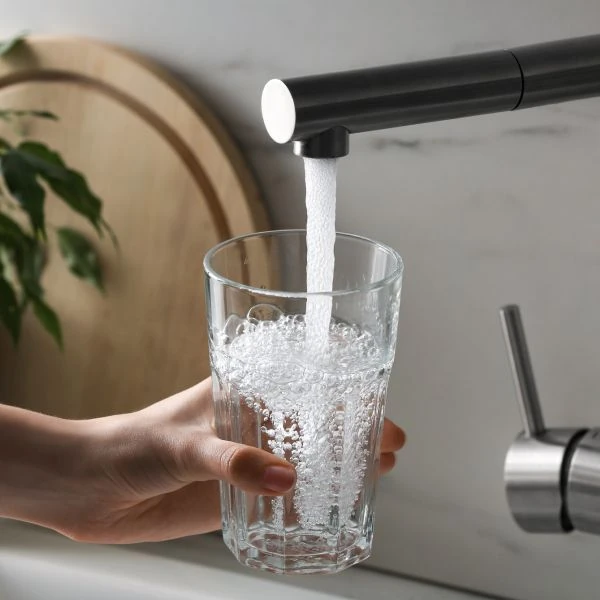 Water from a tap being poured into a drinking glass Water from a tap being poured into a drinking glass